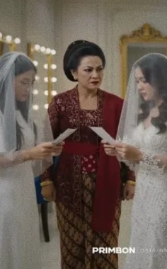 Two brides in white veils compare letters while a mother in red kebaya looks on.