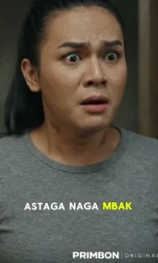 A woman in a grey T-shirt stares in shock.